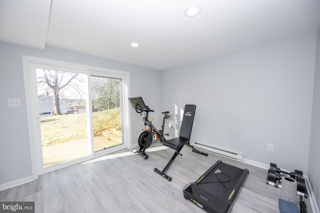 workout room featuring a baseboard heating unit, recessed lighting, wood finished floors, and baseboards