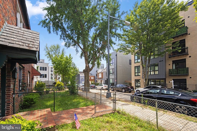 exterior space featuring a residential view and fence