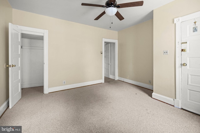 unfurnished bedroom featuring ceiling fan, a closet, carpet, and baseboards