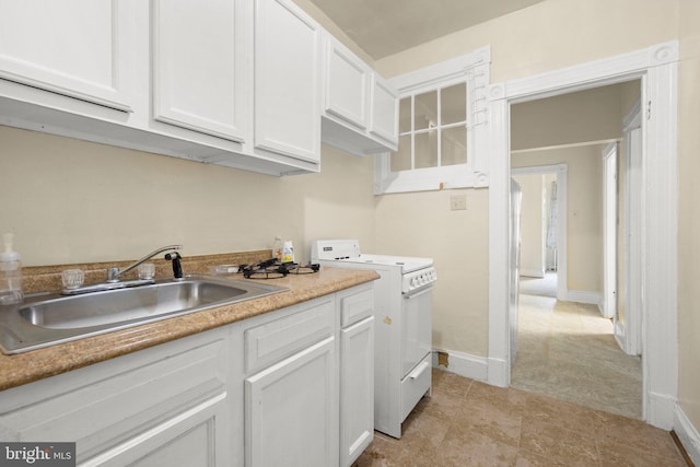 kitchen featuring a sink, white cabinetry, baseboards, light countertops, and white range with electric cooktop