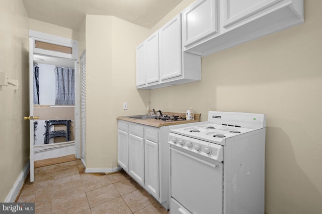 kitchen with light tile patterned floors, a sink, white cabinetry, electric stove, and light countertops