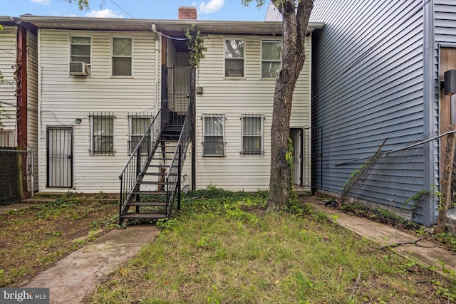 view of property with cooling unit, fence, a chimney, and stairs