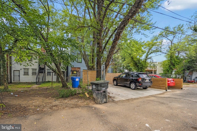 view of parking / parking lot with fence