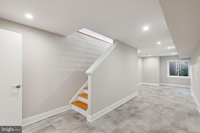 basement featuring stairs, recessed lighting, and baseboards