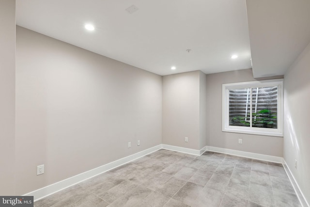 unfurnished room featuring recessed lighting and baseboards