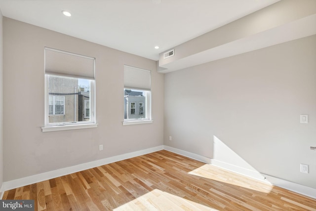 unfurnished room featuring visible vents, recessed lighting, baseboards, and wood finished floors