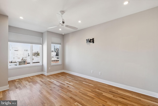 empty room featuring recessed lighting, light wood-type flooring, baseboards, and ceiling fan