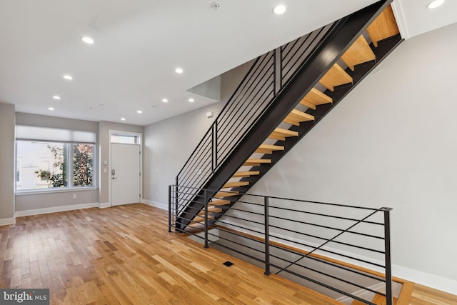 foyer entrance with recessed lighting, baseboards, light wood-style floors, and stairs