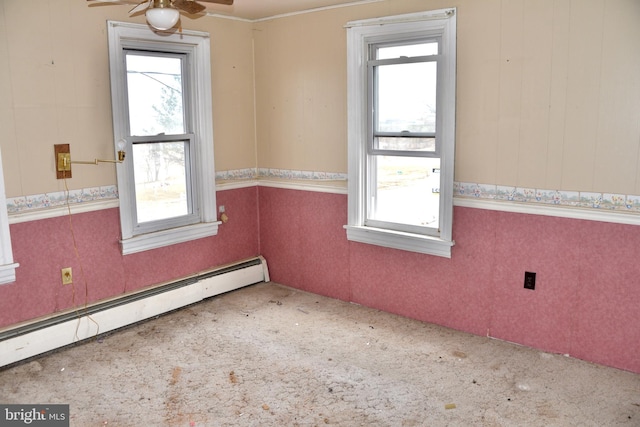 unfurnished room featuring carpet, baseboard heating, plenty of natural light, and wallpapered walls