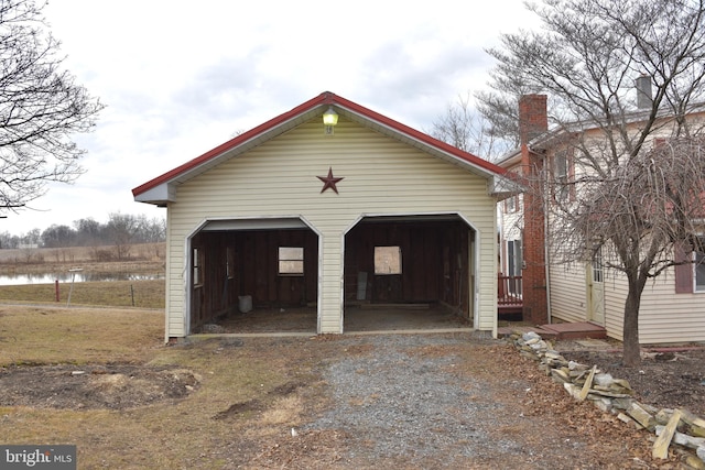 detached garage featuring a water view