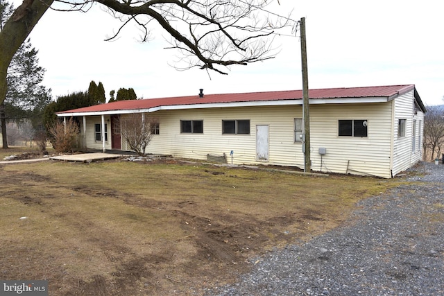 rear view of house featuring metal roof