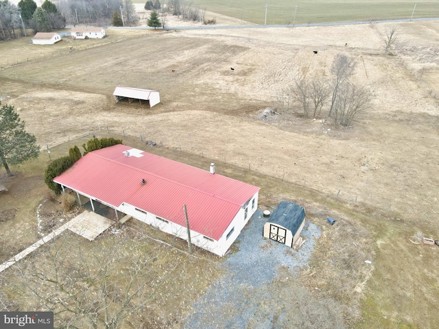 birds eye view of property with a rural view