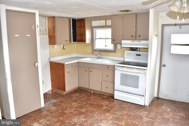 kitchen with electric stove, a sink, light countertops, and under cabinet range hood