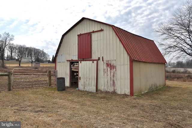 view of pole building with a yard and fence