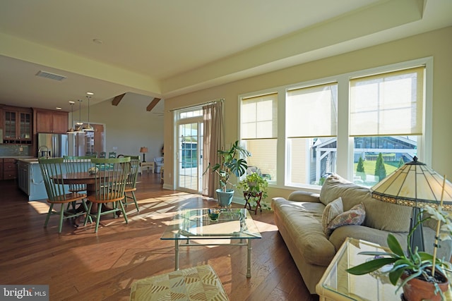 living area featuring visible vents and dark wood-style flooring