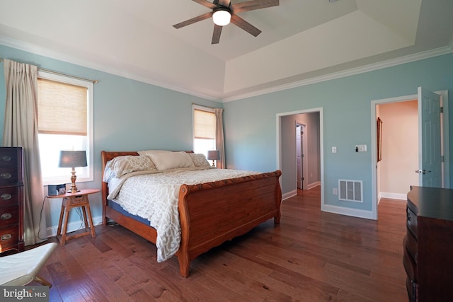 bedroom featuring a raised ceiling, visible vents, dark wood finished floors, and baseboards