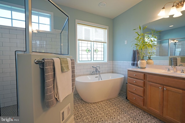 bathroom with visible vents, tile patterned flooring, walk in shower, and a wealth of natural light