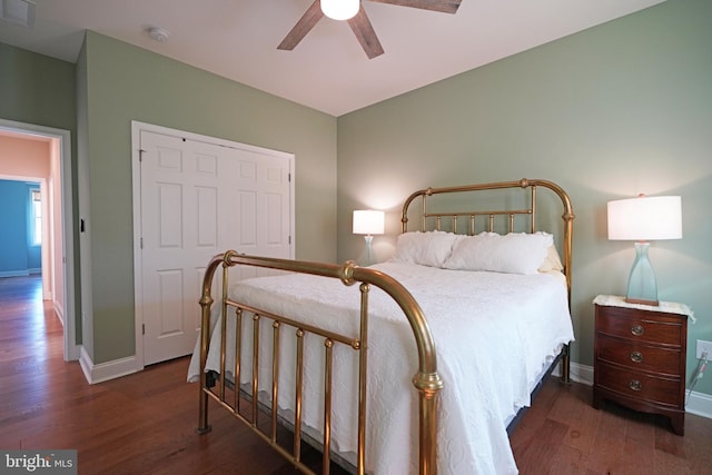 bedroom featuring ceiling fan, wood finished floors, visible vents, and baseboards