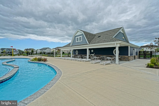 community pool with fence and a patio