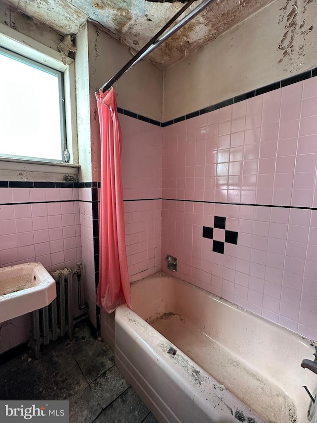 bathroom with shower / tub combo with curtain, tile walls, and radiator heating unit