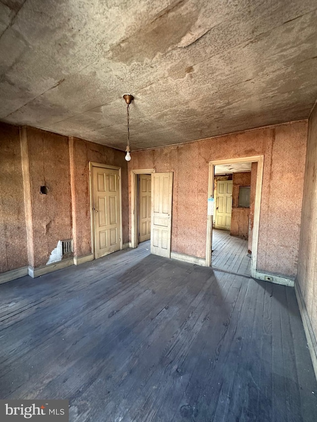 spare room with wood-type flooring