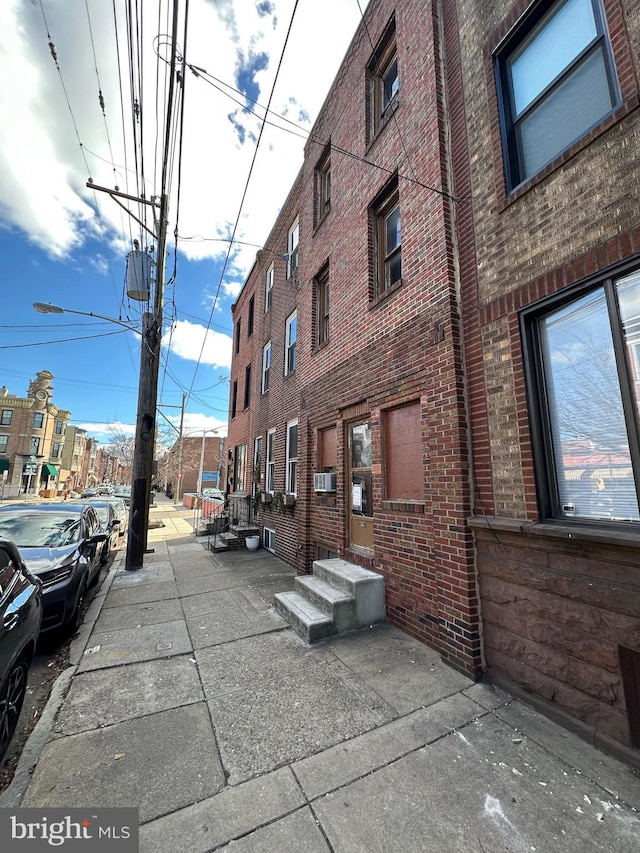 view of property with entry steps and cooling unit