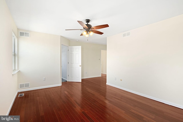 unfurnished room featuring wood finished floors and visible vents