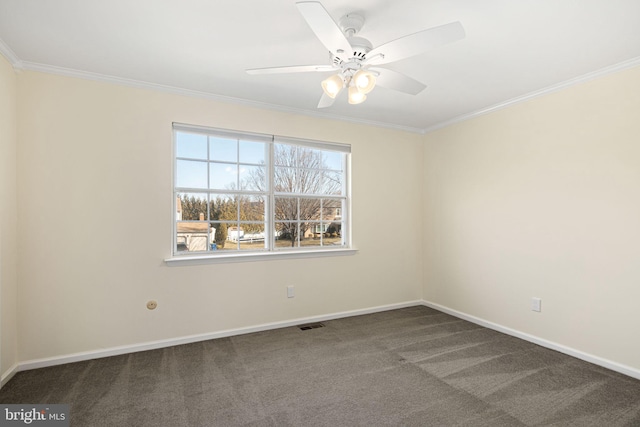 unfurnished room with a ceiling fan, carpet, baseboards, and crown molding