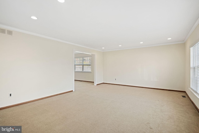 unfurnished room featuring recessed lighting, light carpet, visible vents, baseboards, and crown molding