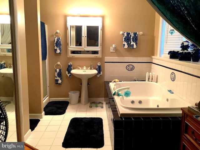 full bathroom with a whirlpool tub, tile patterned flooring, and baseboards