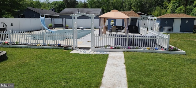 view of front of home with a fenced in pool, a front yard, and a fenced backyard