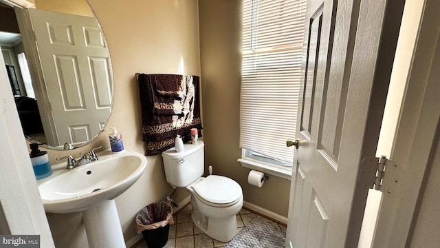 bathroom featuring tile patterned floors, toilet, and baseboards