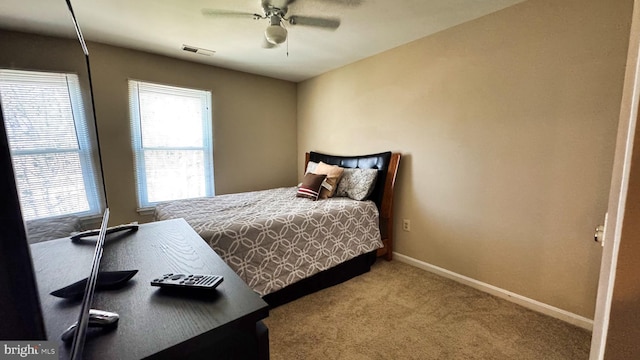 bedroom featuring carpet flooring, baseboards, visible vents, and ceiling fan