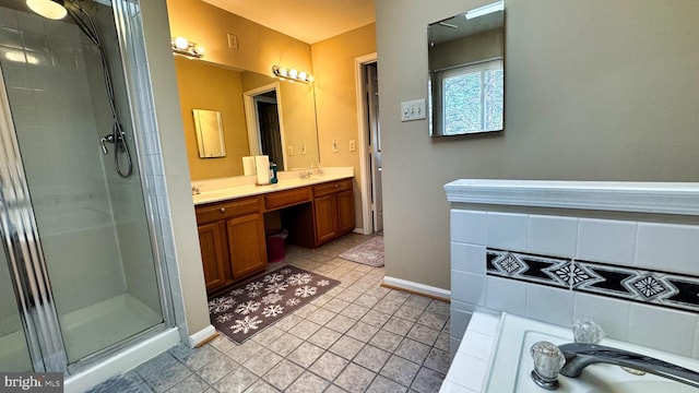 full bath featuring a shower stall, baseboards, a washtub, double vanity, and a sink