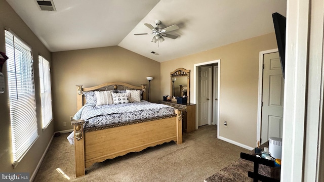 carpeted bedroom featuring vaulted ceiling, baseboards, visible vents, and ceiling fan