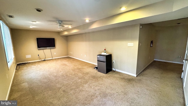 interior space with baseboards, visible vents, carpet floors, and ceiling fan