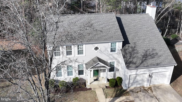 colonial house with a chimney and a shingled roof