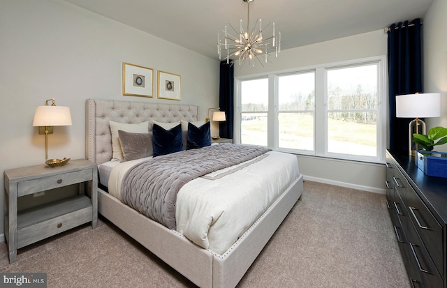 carpeted bedroom with baseboards and a notable chandelier