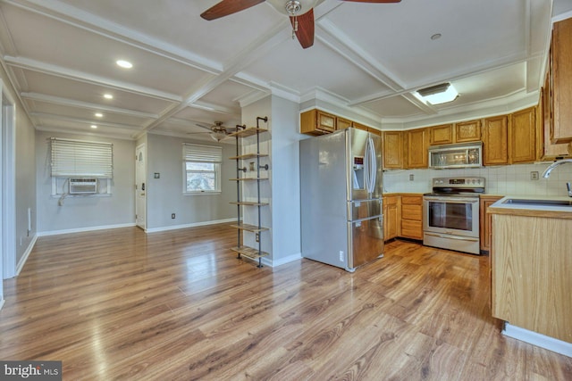 kitchen featuring coffered ceiling, a sink, light wood-style floors, appliances with stainless steel finishes, and tasteful backsplash