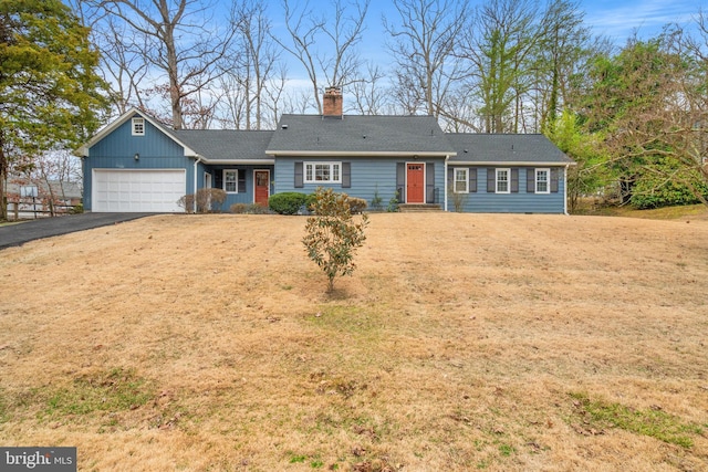 ranch-style home with driveway, a chimney, an attached garage, and roof with shingles