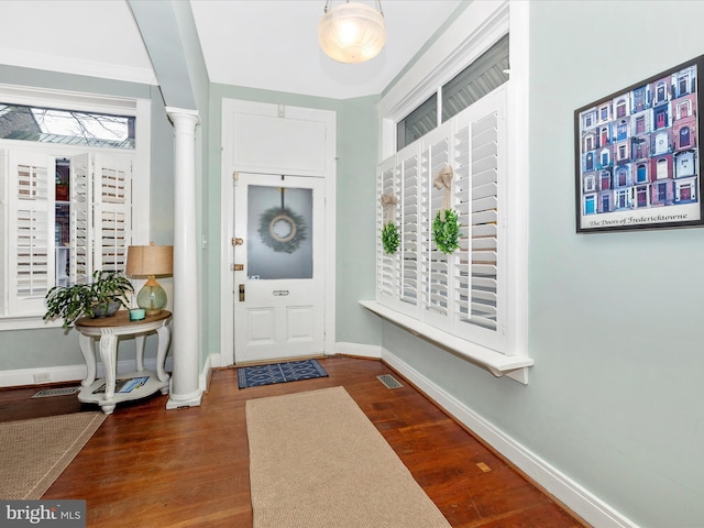 entrance foyer with ornate columns, wood finished floors, visible vents, and baseboards