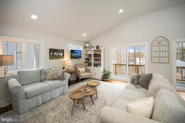 living room with lofted ceiling, wood finished floors, a wealth of natural light, and recessed lighting