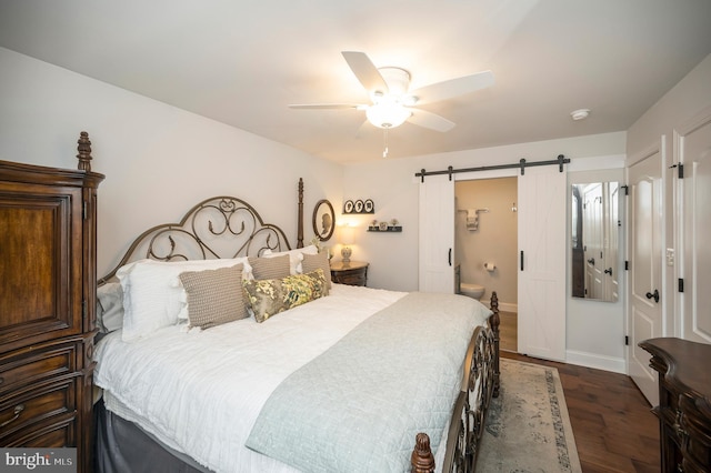 bedroom featuring dark wood-style floors, a barn door, baseboards, and ceiling fan