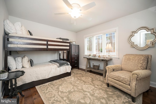 bedroom with ceiling fan, wood finished floors, and baseboards