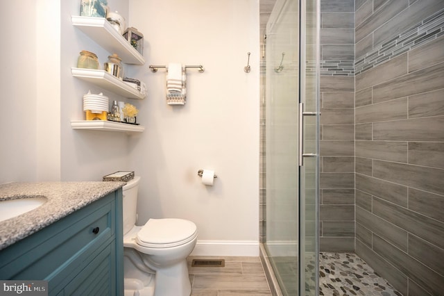 full bath featuring a stall shower, visible vents, vanity, and toilet