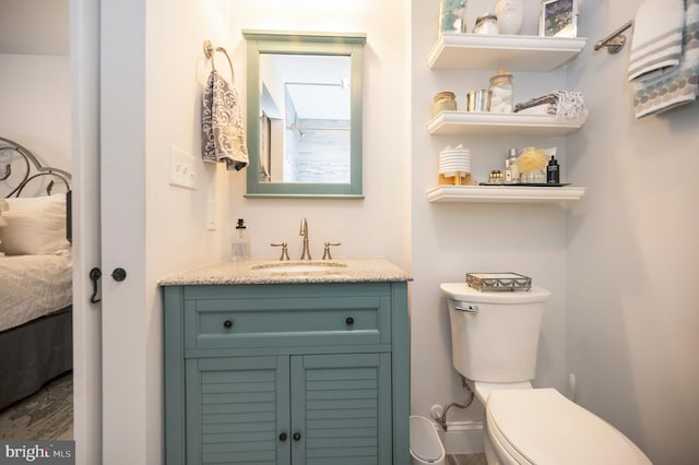 ensuite bathroom with vanity, toilet, and ensuite bathroom