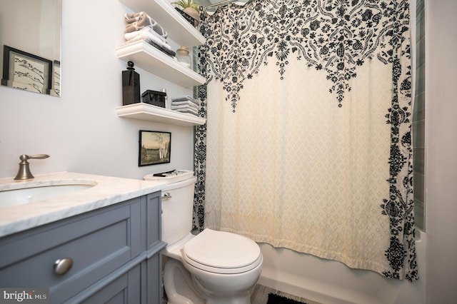 bathroom featuring shower / bath combo, vanity, and toilet