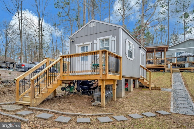 rear view of house with a deck and stairway