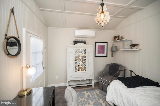 bedroom with a wall mounted air conditioner, wood finished floors, and baseboards