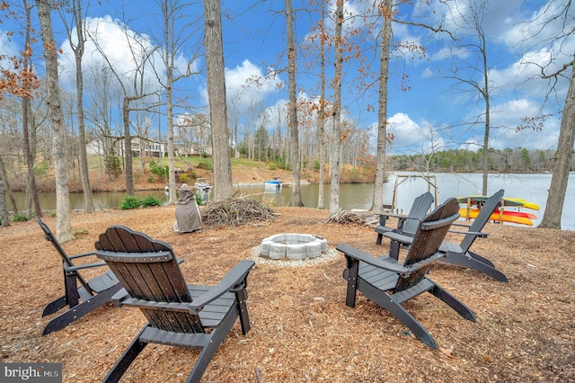 view of yard featuring a water view and an outdoor fire pit